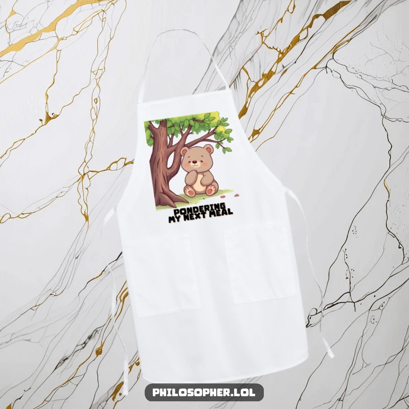 Funny apron showcasing a happy bear sitting under a tree, thinking deeply while cooking, ideal for kitchen humor.