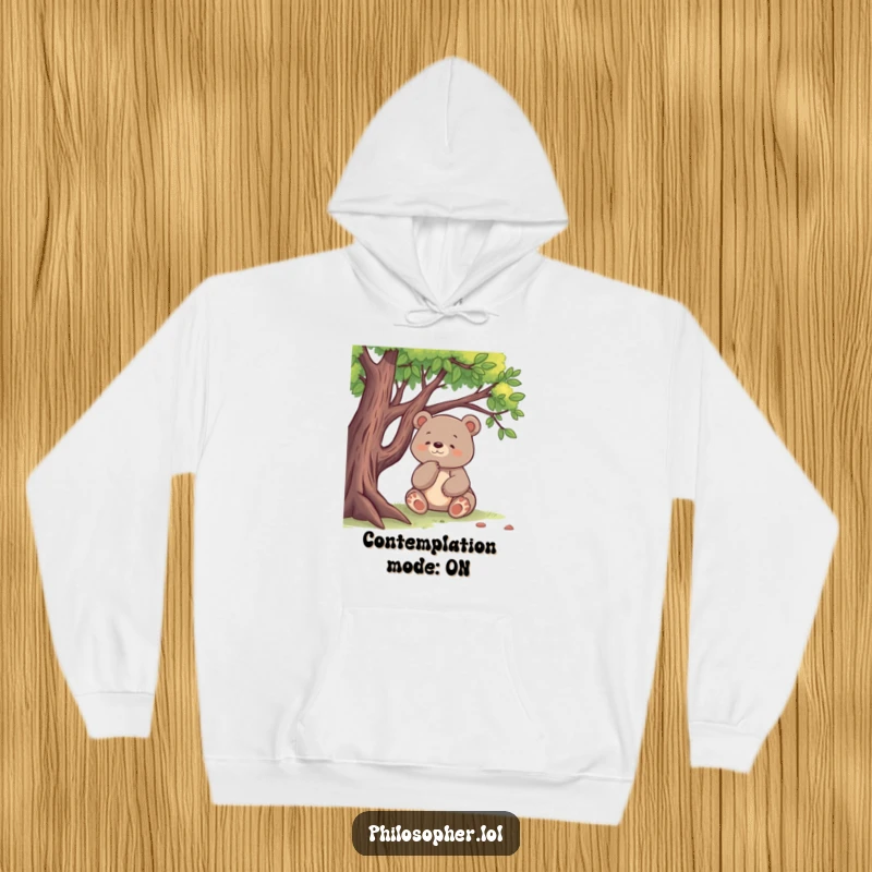 Funny hoodie with a happy bear thoughtfully sitting under a tree, exuding a sense of calm introspection, great humorous gift.