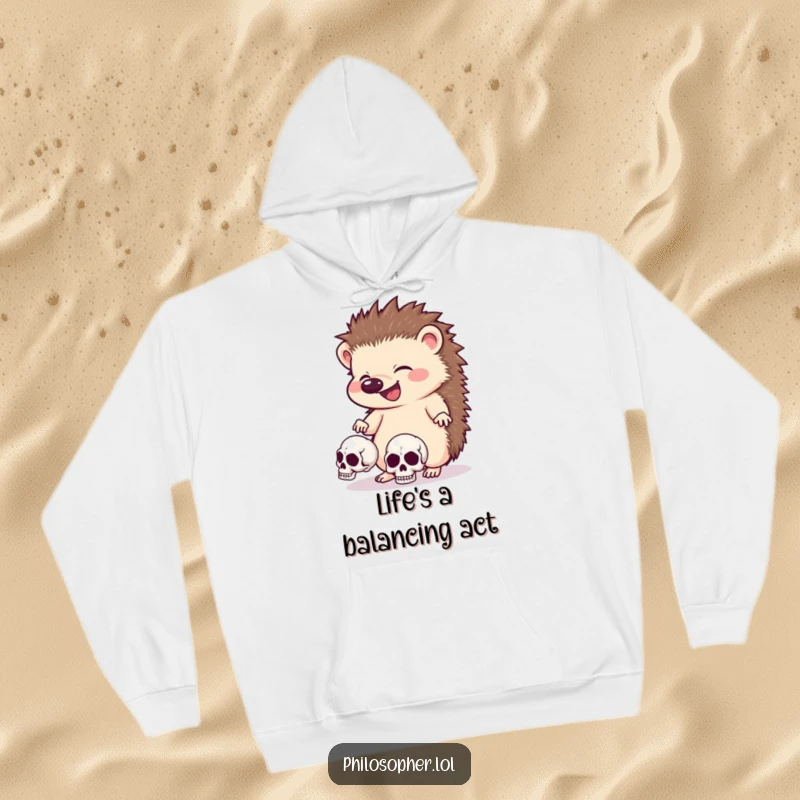 Funny hedgehog hoodie, cozy, giggling animal juggling skulls, dark humor apparel, warm and quirky design.