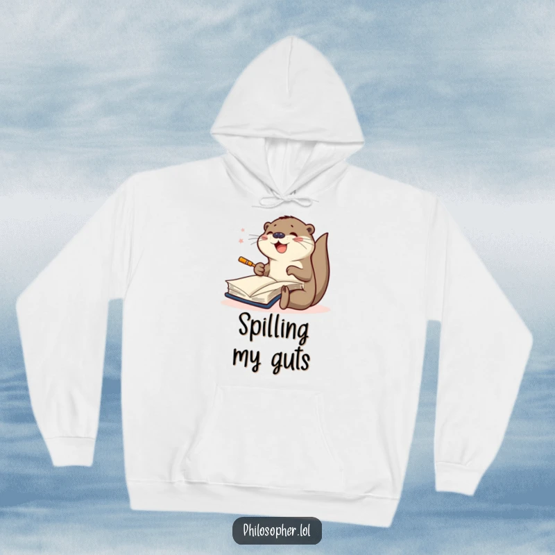 Funny hoodie featuring a joyful otter furiously scribbling in a large book, highlighting dedication to artistic endeavors and creative passion.