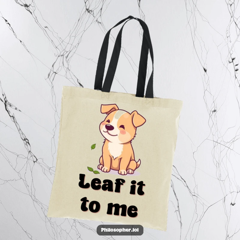 Funny tote bag showcasing a beaming dog contemplating a single scattered autumn leaf, perfect for carrying groceries with a smile.